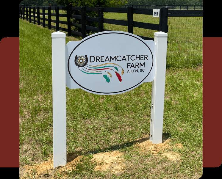 White sign with Dreamcatcher Farm logo